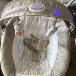 Baby seat with swing, illuminated toy bar and musical vibrator