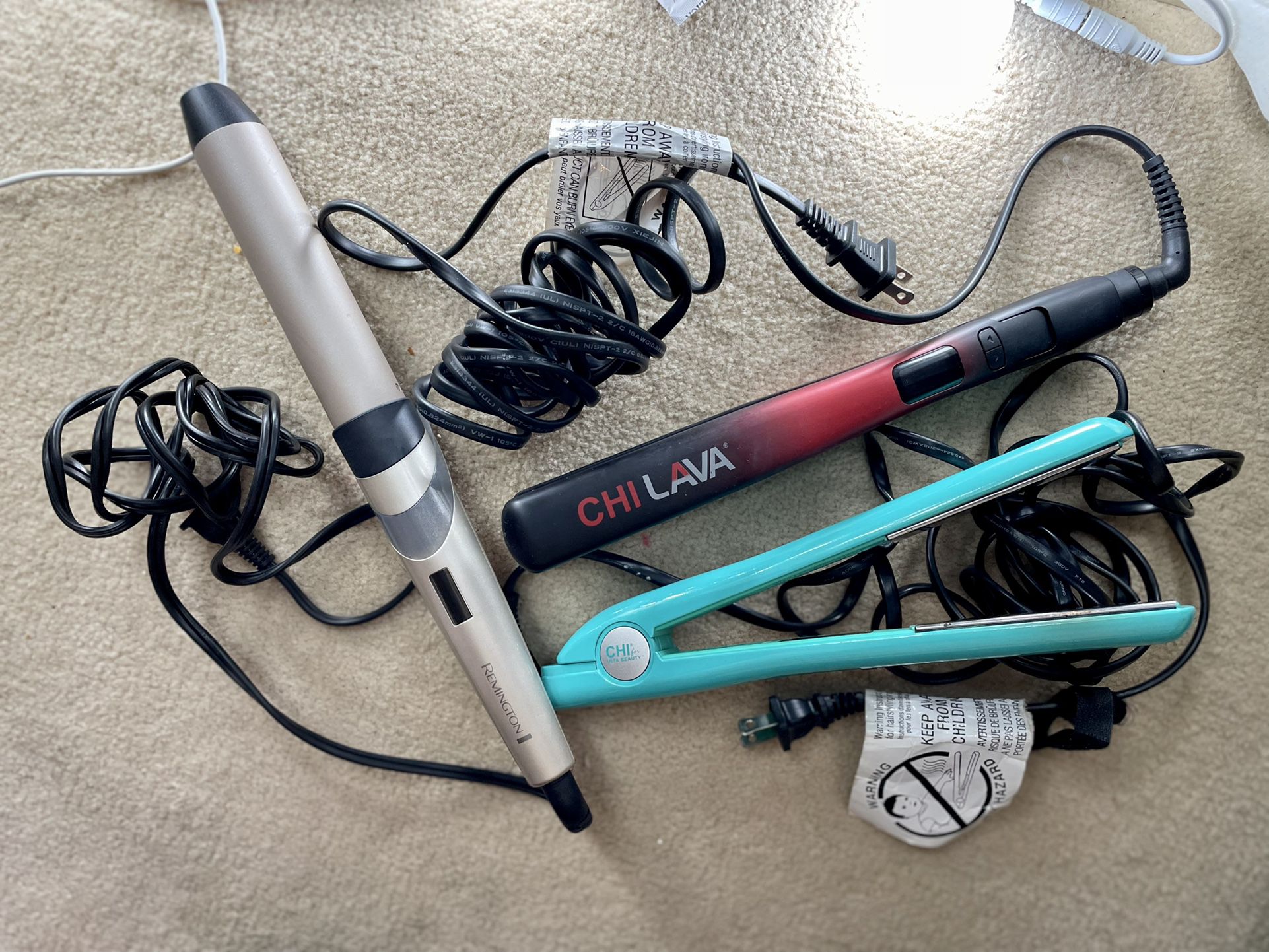 Two Chi Hair Straighteners And One Remington Hair Curler
