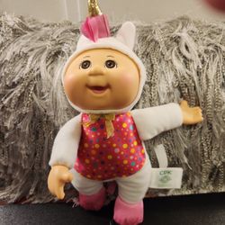 Two Cabbage Patch Kids In Unicorn Costumes.  