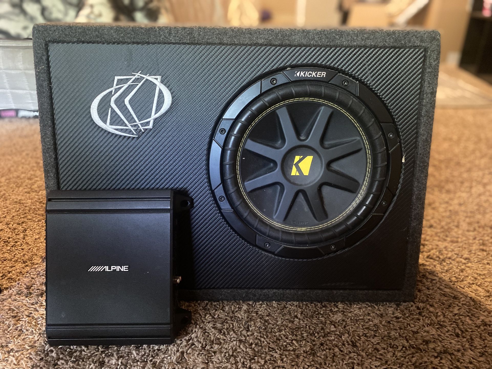 Kicker 43TC104 Comp 10-inch subwoofer with an Alpine MRV-M250 amplifier.