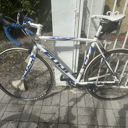 white and blue Fuji Roubaix road bike, likely a 2011 to 2013 model