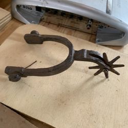 This is a cast iron western-style boot spur. 