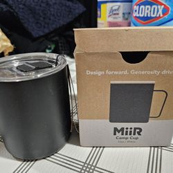 New, well insulated metal cup with handle, Cover and drink sprout.