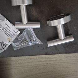 two stainless towel hocks with hardware.