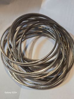 18 intertwined metal bangles