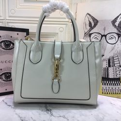 The elegant gold buckle tote bag exemplar.Dimensions: 30 × 24 × 12.

