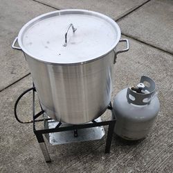 Outdoor Gourmet 60 quart boil pot, stand, and insert with a partially full tank