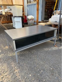 Graphite colored coffee table by IKEA with glass slider windows.