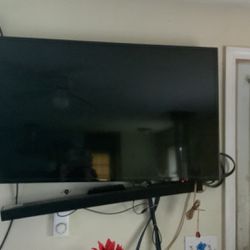 Samsung 55 inch tv with mounting hardware and soundbar