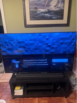 Sony Bravia tv with sound bar and stand