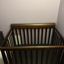 Brown mini crib