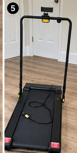 folding treadmill equipped with a foldable handle, phone holder