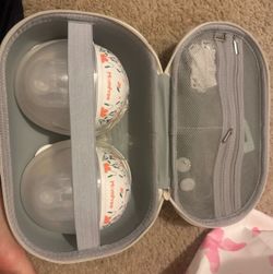 Wearable breast pumps