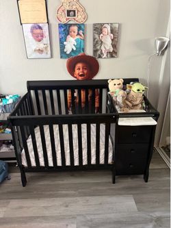 Black baby crib with storage and changing table