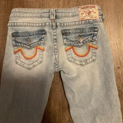  women’s True religion light wash low rise red and orange flare jeans