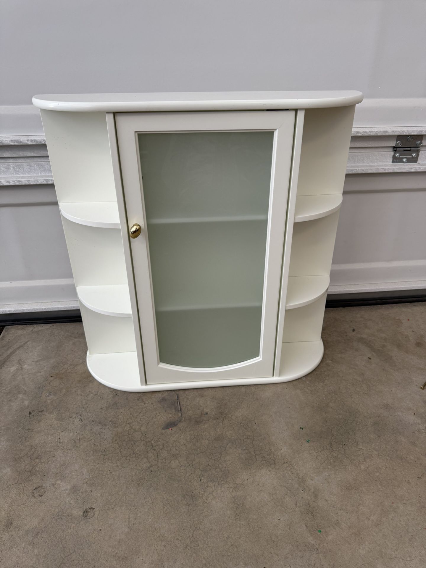 Wall cabinet with glass door.