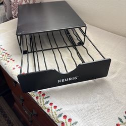 Keurig K-Cup pod storage drawer — it sits under your coffee maker and holds the little coffee pods (K-Cups). You pull the drawer out to organize and g