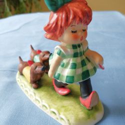 

Goebel Red Head with dachshunds “Putting on the dogs” 1953 BYJ 25 5.5”H 

