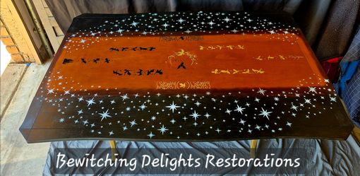 Beautifully refurbished vintage drop leaf dining room table in a dragon fantasy design