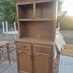 classic solid wood china hutch used for displaying tableware and providing storage. 