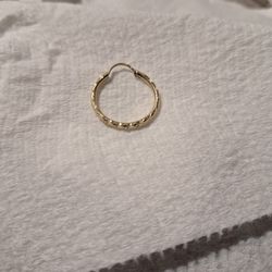 14K Yellow Gold Diamond-Cut Hoop Earring. These earrings are characterized by a geometric, textured pattern that is "diamond-cut"