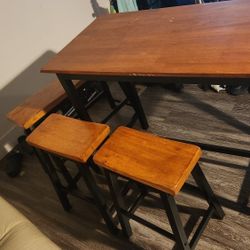 A stool table with stool chairs 