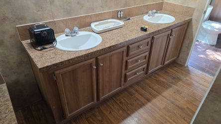 Bathroom vanities with sinks and faucets.