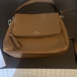 Stylish Tan  Kate Spade handbag with tassel detail.