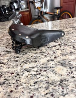 Persons hand made leather bike seat
