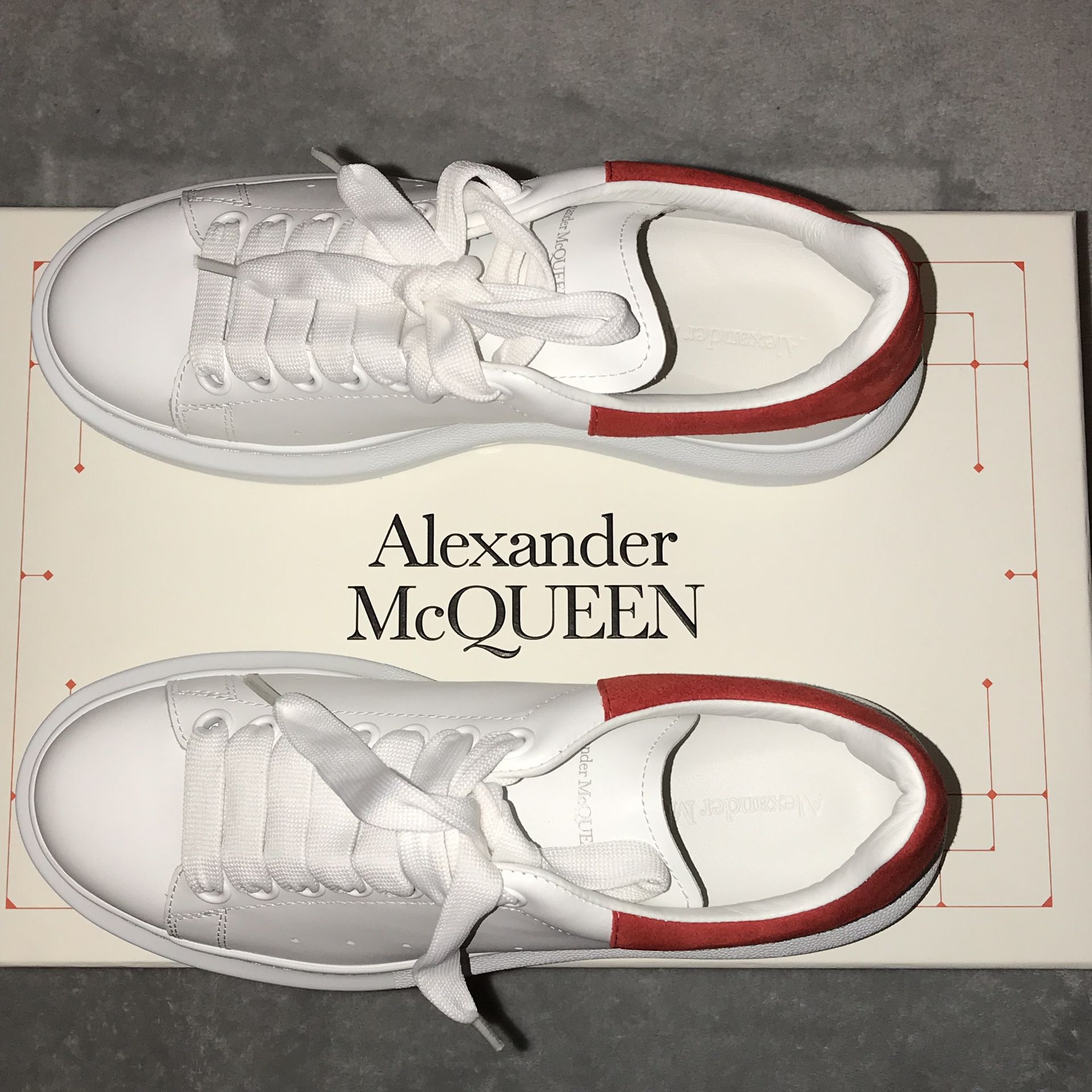 Alexander McQueen women’s size 8. White & Red Oversized Sneakers. Round toe. Suede heel tab in back featuring logo stamped in gold-tone.