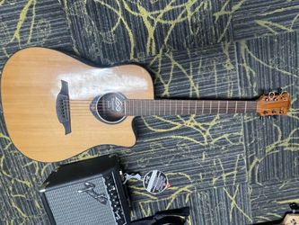 Acoustic guitar with connection for amp