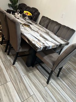 Marble dining table—like new—with 6 fabric chairs.