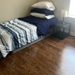 Single Bed Along With Bed Side Table And A Lamp