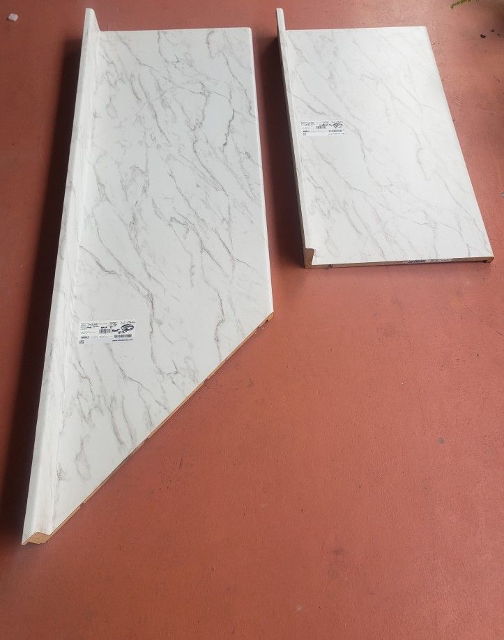 Laminate Countertop in Textured Anzio Marble with Waterfall Edge and Integrated Backsplash