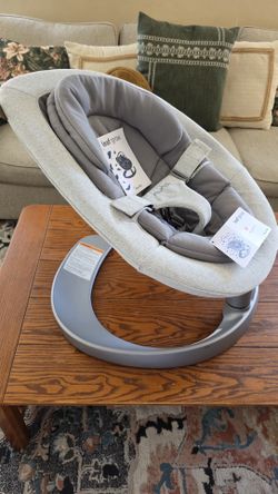 Nuna LEAF Grow baby lounger in a light grey color.