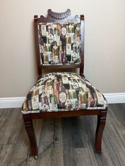 Antique Hand Carved Wood Accent Chair with Vintage Wine Bottle Upholstery & Front Casters $65 OBO