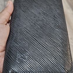 Authentic Louis Vuitton Zippy Wallet crafted from black Epi leather. 