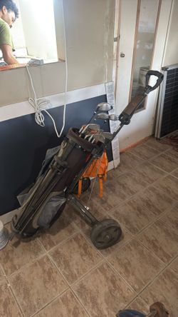 Golf caddy with golf clubs and plenty of golf balls