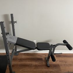 Weight bench with rack, leg extension, and hamstring curl