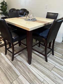 Marble dining table with four chairs.