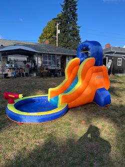 Inflatable slide/pool with working water cannon.