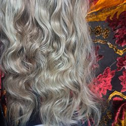 One hundred percent real human hair twenty two inch long halo blonde with dark lawn highlights