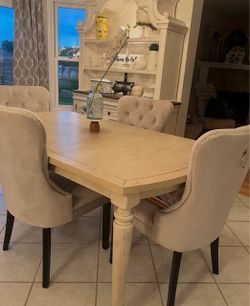 Farmhouse, rustic table with four stud detail chairs.