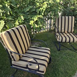 two sunbrella cushioned rocking chairs