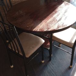 faux wood rod iron dining room table with four chairs