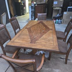 Nice Dining Table Set With Six Chairs. Bought from Ashley Furniture for 2 grand . It comes with four Matching Chairs (suede color) with two captain ch