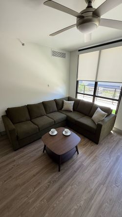 Living Spaces Green Couch L Shaped Sectional & Dark Wood Coffee Table