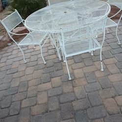 Iron patio table white it does need paint so the prices less if I painted it will be more comes with four chairs and it's about 45 years old