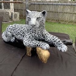 The Snow, Leopard And The Log Statue