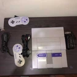Super Nintendo With Two Controllers And Super Mario, All Stars And Punch Out